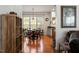 Charming dining room featuring hardwood floors, a modern chandelier, and large bright windows at 241 Lifeson Way, Cary, NC 27519