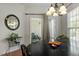 Dining area with a slider door to the screened-in porch, a modern chandelier and great natural light at 241 Lifeson Way, Cary, NC 27519
