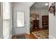 Welcoming foyer with hardwood floors, decorative rug, and ample natural light, creating a warm entry at 241 Lifeson Way, Cary, NC 27519