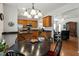 Open concept kitchen view from the dining area featuring stainless steel appliances, dark counters and wooden cabinets at 241 Lifeson Way, Cary, NC 27519