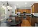 Eat-in kitchen with stainless steel appliances, wooden cabinets, and granite countertops at 241 Lifeson Way, Cary, NC 27519