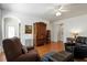 Inviting living room with a ceiling fan, hardwood floors, and elegant furniture and an arched doorway at 241 Lifeson Way, Cary, NC 27519