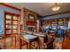 Relaxing lounge area with leather seating, stone fireplace, and built-in shelving at 241 Lifeson Way, Cary, NC 27519