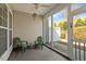 Relaxing screened patio featuring green chairs, perfect for outdoor enjoyment with an open view to the backyard at 241 Lifeson Way, Cary, NC 27519