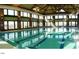 Indoor lap pool with lane markers, with many windows letting in plenty of light at 241 Lifeson Way, Cary, NC 27519