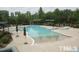 Resort style community pool with umbrellas and lounge chairs at 241 Lifeson Way, Cary, NC 27519