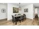 Elegant dining room with stylish light fixture, decorative wall art, and comfortable seating at 2436 Fiddich Ln, Fuquay Varina, NC 27526