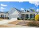 Charming single-Gathering home featuring a two-car garage, dormer windows, and landscaped yard at 2436 Fiddich Ln, Fuquay Varina, NC 27526
