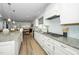 Modern kitchen featuring granite counters, white cabinets and stainless steel appliances at 2436 Fiddich Ln, Fuquay Varina, NC 27526