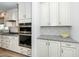 Kitchen area with a double oven, granite countertops and tile backsplash at 2436 Fiddich Ln, Fuquay Varina, NC 27526