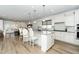 Bright, open kitchen with large island, modern appliances, and adjacent living area at 2436 Fiddich Ln, Fuquay Varina, NC 27526