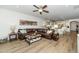 Spacious living room featuring hardwood floors, seating and an open floor plan to the kitchen at 2436 Fiddich Ln, Fuquay Varina, NC 27526