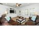 Bright living room featuring hardwood floors, plush seating, and built-in shelving at 2436 Fiddich Ln, Fuquay Varina, NC 27526