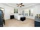 Bright main bedroom featuring neutral tones, a tray ceiling and shuttered windows at 2436 Fiddich Ln, Fuquay Varina, NC 27526