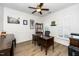 Well-lit home office with wood floors, decorative wainscoting, and ample workspace at 2436 Fiddich Ln, Fuquay Varina, NC 27526