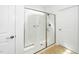 All-white shower stall features clear glass enclosure and a built in bench at 2436 Fiddich Ln, Fuquay Varina, NC 27526