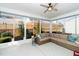 Bright sunroom boasts large windows, a ceiling fan, and comfortable seating area overlooking the yard at 2436 Fiddich Ln, Fuquay Varina, NC 27526