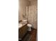 Cozy bathroom featuring a traditional vanity with modern fixtures and nautical-themed shower curtain at 319 Davis Rd, Hillsborough, NC 27278