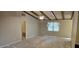 Bright bedroom with vaulted ceiling, ceiling beams, neutral paint and large window at 319 Davis Rd, Hillsborough, NC 27278