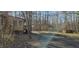 Exterior shot of home with covered parking, and shed in wooded lot at 319 Davis Rd, Hillsborough, NC 27278