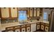 Bright kitchen featuring traditional cabinets with tile backsplash, laminate countertops, and stainless sink at 319 Davis Rd, Hillsborough, NC 27278