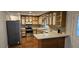 Kitchen features stainless appliances, contrasting cabinetry, decorative backsplash, and laminate countertops at 319 Davis Rd, Hillsborough, NC 27278