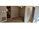 Cozy living room with neutral walls, carpeted floors, and an open view to the kitchen at 319 Davis Rd, Hillsborough, NC 27278