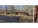 Exterior shot of an enclosed shed in a treed, wooded lot at 319 Davis Rd, Hillsborough, NC 27278