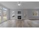 Bright living room with fireplace, large windows, and attractive flooring at 3525 La Costa Way, Raleigh, NC 27610