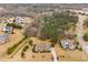 Aerial view of a home with well-maintained landscaping and a long driveway in a quiet neighborhood at 4017 Olde Waverly Way, Fuquay Varina, NC 27526