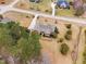 An aerial view of a home featuring lush landscaping, mature trees, and a driveway at 4017 Olde Waverly Way, Fuquay Varina, NC 27526