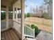 Back porch with stairs, wooden floors, and access to the expansive backyard at 4017 Olde Waverly Way, Fuquay Varina, NC 27526