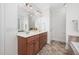 Bathroom features a vanity with double sinks, tile floors, and a large mirror at 4017 Olde Waverly Way, Fuquay Varina, NC 27526