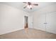 Neutral bedroom featuring carpet, a ceiling fan, closet, and access to another room at 4017 Olde Waverly Way, Fuquay Varina, NC 27526
