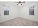 Cozy bedroom with a ceiling fan, carpeted floor, and windows for natural light at 4017 Olde Waverly Way, Fuquay Varina, NC 27526