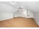 Large bonus room with light wood floors, ceiling fan, and multiple access doors at 4017 Olde Waverly Way, Fuquay Varina, NC 27526