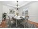 Formal dining room featuring chandelier lighting, white walls, and hardwood flooring at 4017 Olde Waverly Way, Fuquay Varina, NC 27526