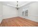 Dining room with crown molding, chandelier, and hardwood floors at 4017 Olde Waverly Way, Fuquay Varina, NC 27526