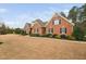 Sprawling brick home with a large lawn and well-maintained landscaping at 4017 Olde Waverly Way, Fuquay Varina, NC 27526