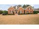 Beautiful brick home with a manicured lawn and mature landscaping showcasing classic curb appeal at 4017 Olde Waverly Way, Fuquay Varina, NC 27526