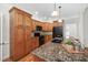 Spacious kitchen featuring granite countertops, stainless steel appliances, and wood cabinets at 4017 Olde Waverly Way, Fuquay Varina, NC 27526