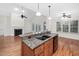 Kitchen featuring hardwood floors, granite counters, and view of the fireplace at 4017 Olde Waverly Way, Fuquay Varina, NC 27526