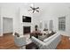 Bright living room featuring vaulted ceilings, fireplace, hardwood floors, and modern decor with lots of natural light at 4017 Olde Waverly Way, Fuquay Varina, NC 27526