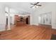 Open floor plan with hardwood floors, kitchen and dining area, and vaulted ceilings at 4017 Olde Waverly Way, Fuquay Varina, NC 27526