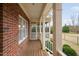 Enclosed porch showcasing a wooden floor, screen windows, and access to the backyard at 4017 Olde Waverly Way, Fuquay Varina, NC 27526