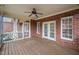 Outdoor porch featuring brick walls, ceiling fan, screen windows, and wooden floors at 4017 Olde Waverly Way, Fuquay Varina, NC 27526