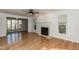 Bright living room boasting hardwood floors, a fireplace, and large windows overlooking the backyard at 4204 New Brighton Dr, Apex, NC 27539