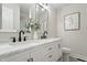 Bright bathroom featuring double vanity sinks and a modern backsplash at 4307 Pope Rd, Durham, NC 27707