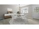 Cozy dining room area with modern chandelier, natural light and seating for four at 4307 Pope Rd, Durham, NC 27707