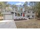 Two-story house with red door, white garage door, and mature trees at 4307 Pope Rd, Durham, NC 27707